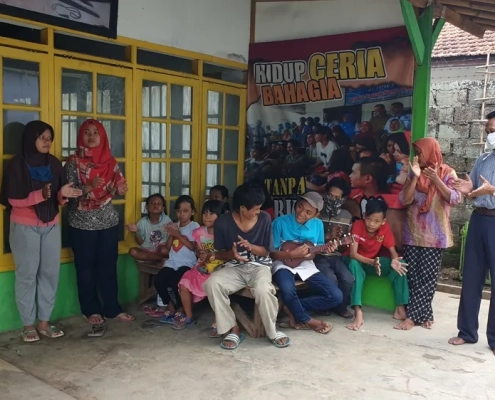 Children gather outside the shelter in Depok in West Java. The building offers a place of refuge [Jessica Washington/Al Jazeera]