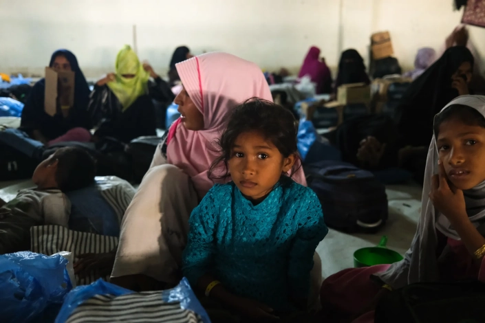 Late last year, a group of university students stormed a car park where Rohingya refugees were sheltering, demanding their deportation and forcing the group out of the shelter and onto trucks. Video of the incident showed the students screaming and burning tyres, while the Rohingya children cried with fear. [Jessica Washington /Al Jazeera]