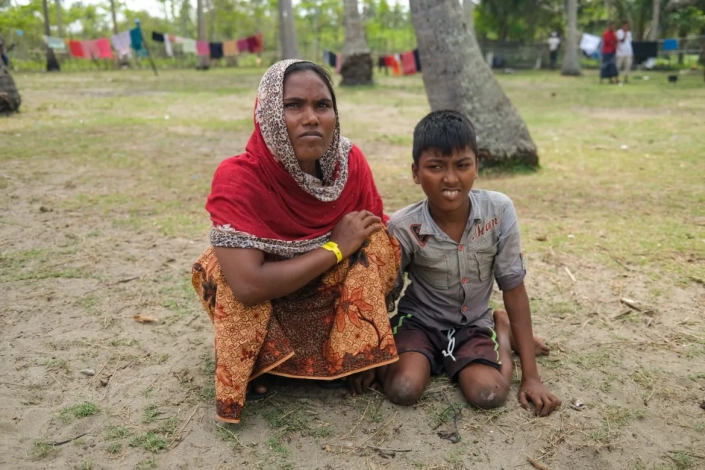 Nur Begum said she struggles to care for her son, who cannot walk. 'As he gets heavier, it’s harder for me to lift him when he needs to urinate or defecate,' she said. She told Al Jazeera she regrets her decision to come to Indonesia. [Jessica Washington /Al Jazeera]