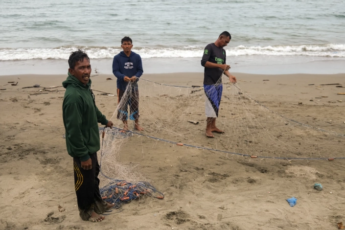 These fishermen live in a village that includes the same beach where the refugees are sheltering temporarily. 'If I see more Rohingya at sea, I will tell them to leave. We won’t allow them to disembark,' one fisherman said. [Jessica Washington /Al Jazeera]