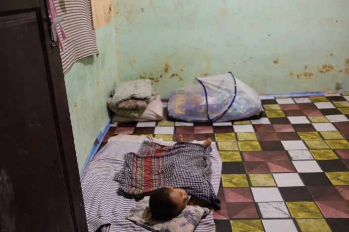 The family of four lives in this room at the temporary shelter in Pidie. [Jessica Washington/Al Jazeera]